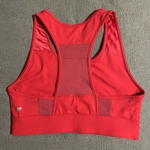 Red Fabletics sports bra with mesh back pocket